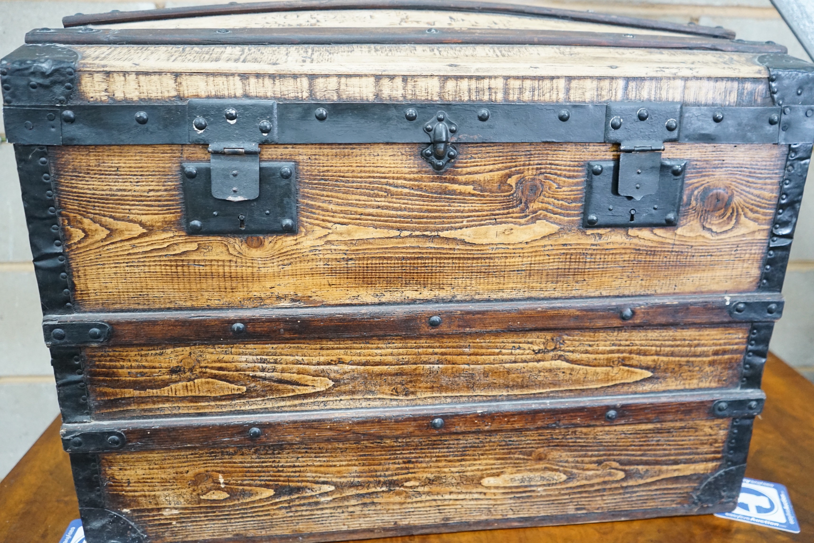 A metal bound domed top steamer trunk, 57 cm high, 76 cm wide, 49 cm